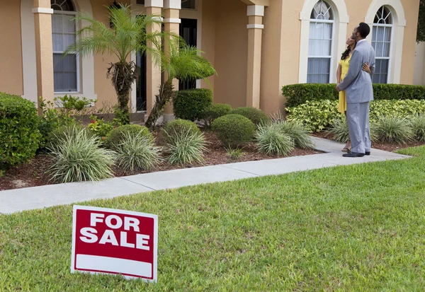 stock image African American Couple Beside House For Sale Sign