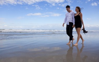 Romantic Man and Woman Couple Walking On A Beach clipart