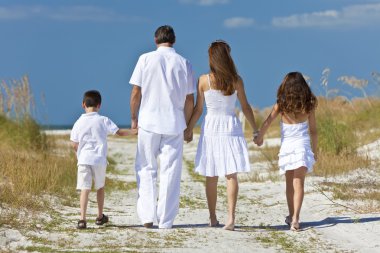 Mother, Father and Children Family Walking At Beach clipart