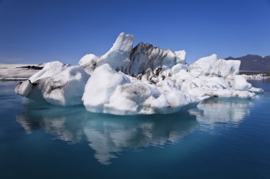 Iceberg and Reflection on the Lagoon, Jokulsarlon, Iceland clipart