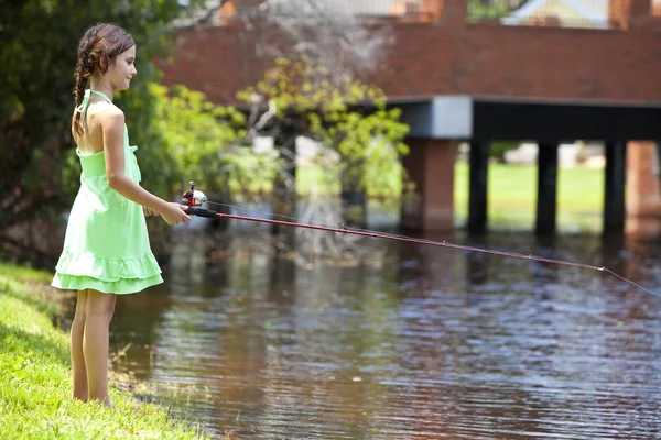 Bastante joven niña pesca en un río —  Fotos de Stock