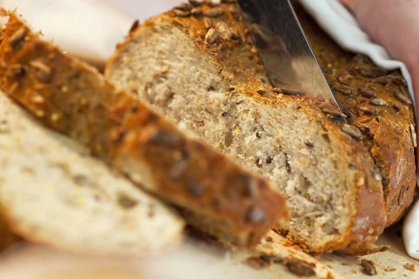 Close up of Slicing Rustic Wholemeal Seeded Loaf of Bread — Stock Photo, Image