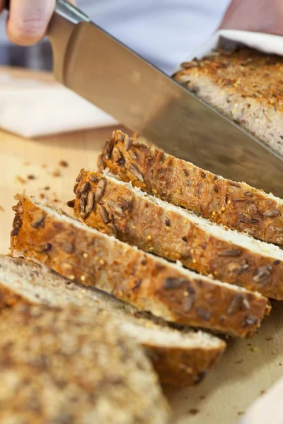 Close up of Slicing Rustic Wholemeal Seeded Loaf of Bread — Stock Photo, Image