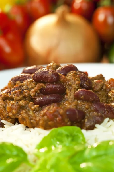 stock image Chili Con Carne On Rice With Basil Garnish