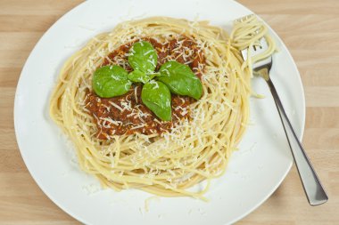 Spaghetti Bolognese With Basil Garnish and Grated Parmesan Chees clipart