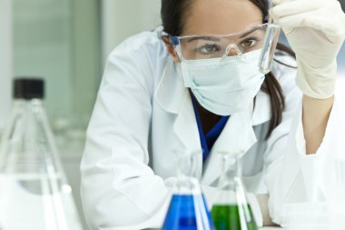 Female Scientist or Woman Doctor With Test Tube In Laboratory clipart