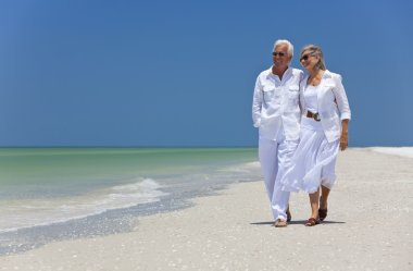 Happy Senior Couple Dancing Walking on A Tropical Beach clipart