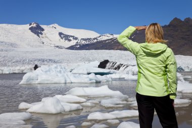 Environmental Concept Woman Hiker Looking At Melting Glacier clipart