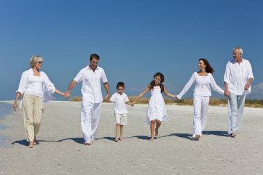 Three Generations of Family Walking Holding Hands on Beach clipart