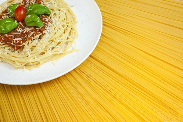 Plate of Spaghetti Bolognese on A Sunny Display of Dried Pasta — Stock Photo, Image