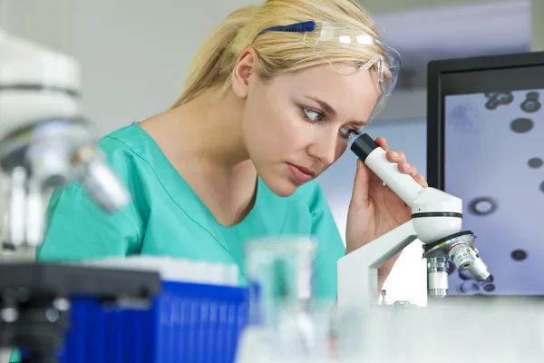 Científica o doctora usando microscopio en laboratorio — Foto de Stock
