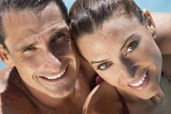 Beautiful Couple Relaxing in Swimming Pool with Perfect Smiles — стоковое фото