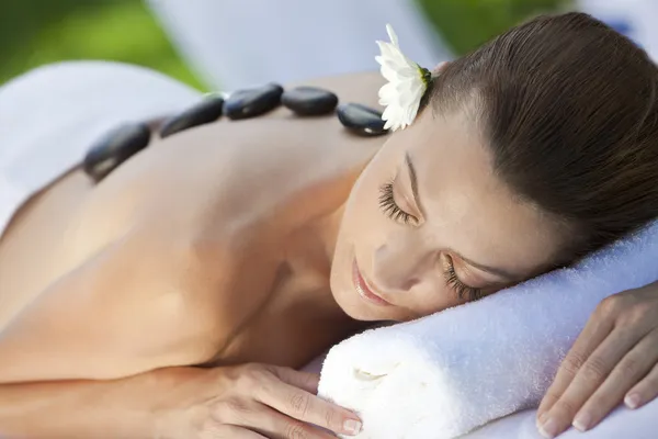 Femme se relaxant au spa de santé ayant massage de traitement de pierre chaude — Photo