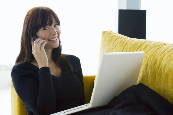Beautiful Happy Woman Using Laptop Computer & Telephone at Home — Stock Photo, Image
