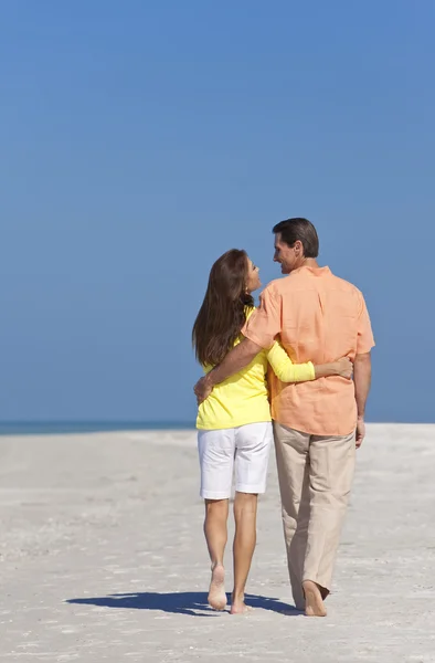Romántica pareja feliz caminando en una playa — Foto de Stock