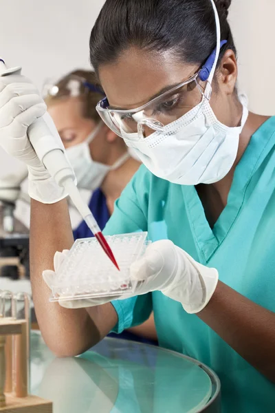 在 laborat 中使用吸管及血液样本的亚洲女性科学家 — 图库照片