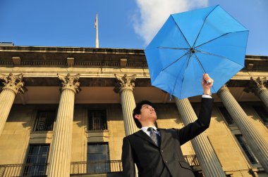 Conceptual pic of Asian Man with an umbrella clipart