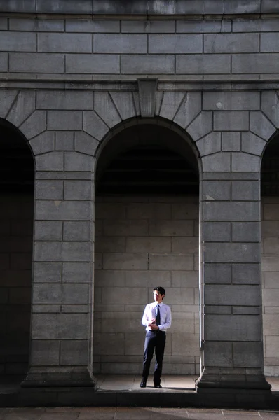 stock image Asian Chinese Man standing in the arch of a roman architecture