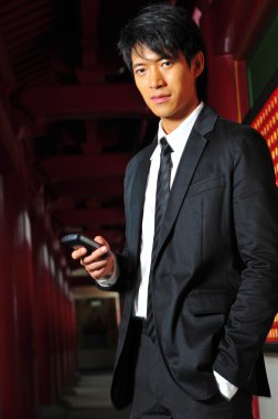 Asian Chinese Man with mobile phone clipart