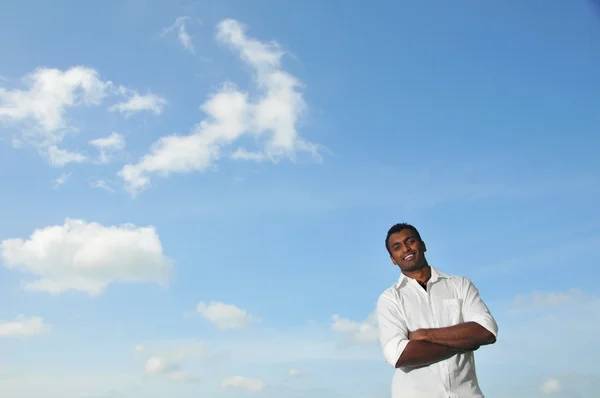 Indický muž pod modrou oblohu s úsměvem — Stock fotografie