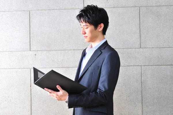 Asian Student looking at his file — Stock Photo, Image
