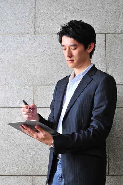 Asian Student looking at his file — Stock Photo, Image