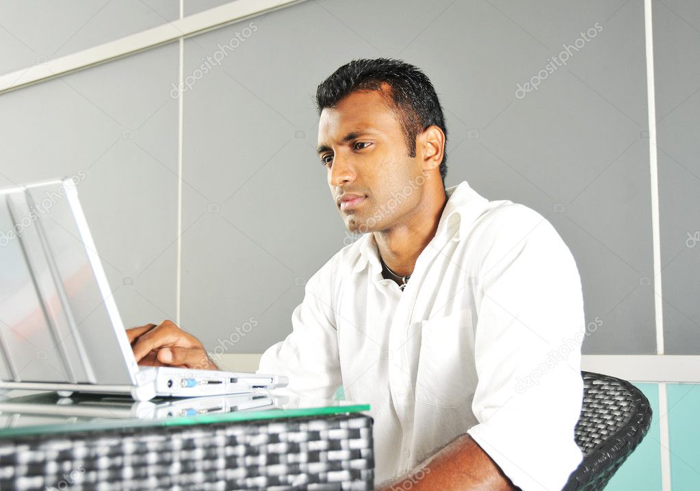 Indian IT person managing laptop and data information