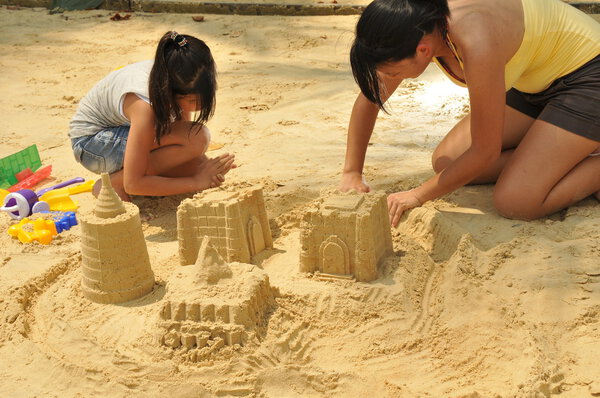 Asian chinese girls playing in the sand