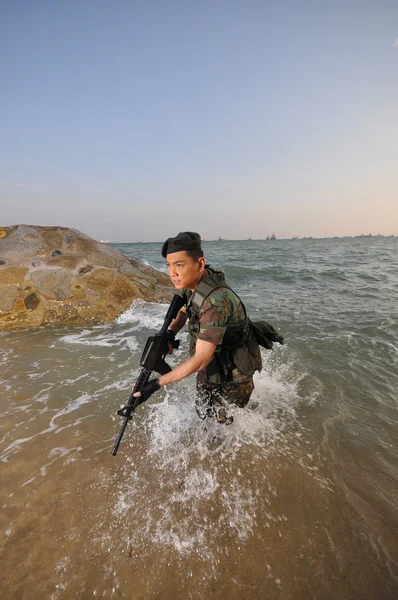 Asian soldier by the beach — Stock Photo, Image