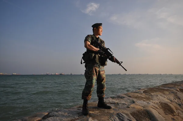 stock image Asian soldier by the beach