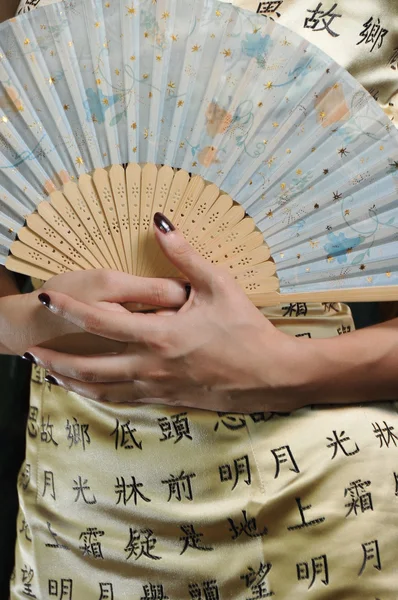 Asian chinese lady with a fan in her hand — Stock Photo, Image