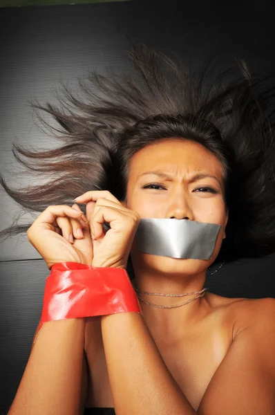 Asian chinese girl with tape over her mouth Royalty Free Stock Images