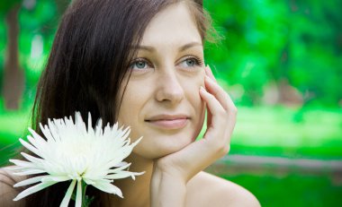 Portrait of a cute young female with flower