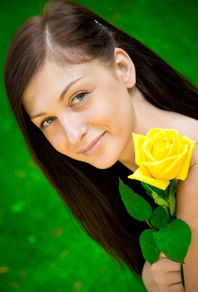 Portrait of a cute young female with flower — Stok fotoğraf