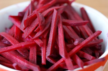 Plate with slices of beets is on the table clipart