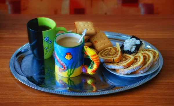 stock image Two cups of tea, biscuits and rolls on a tray