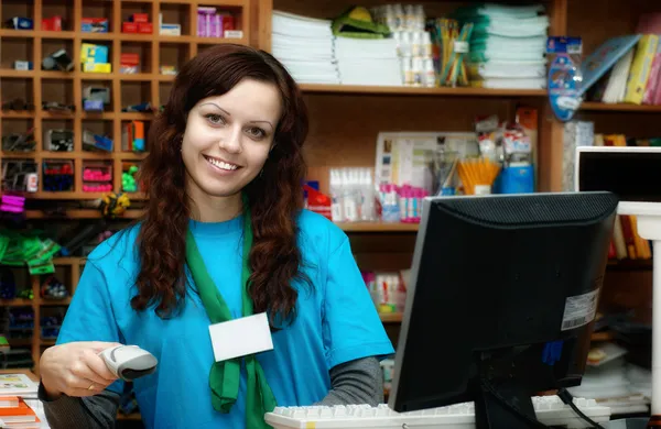 A young girl works as a cashier in store — Stock Photo, Image