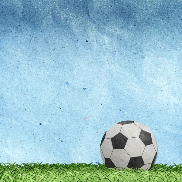 Voetbal op veld gerecycleerd papier ambachtelijke — Stockfoto