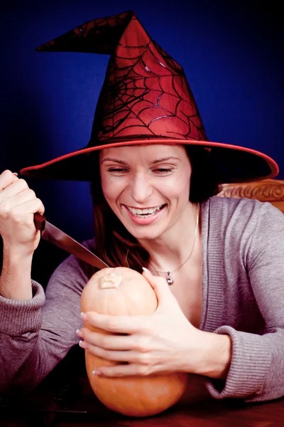 Smiling witch with pumpkin — Stock Photo, Image
