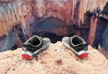 Shoes of the suicide on the brink of a precipice clipart