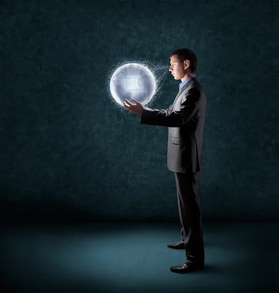 Businessman holding glowing planet earth — Stock Photo, Image