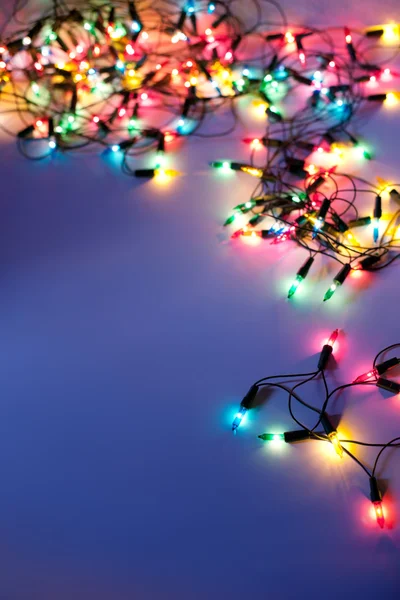 Christmas lights on dark blue background with copy space. Decora — Stok fotoğraf