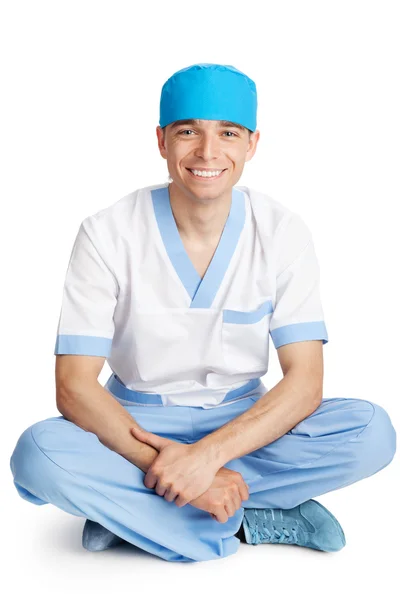 Médico con gorra sentado en pose de loto —  Fotos de Stock