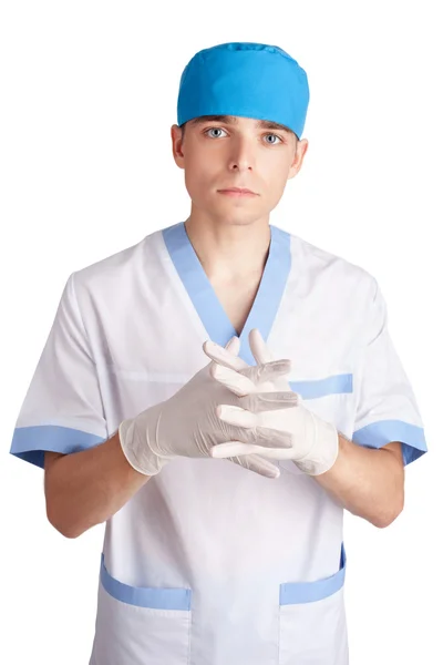 Молодой серьезный врач в перчатках, изолированных на белом пляже — стоковое фото