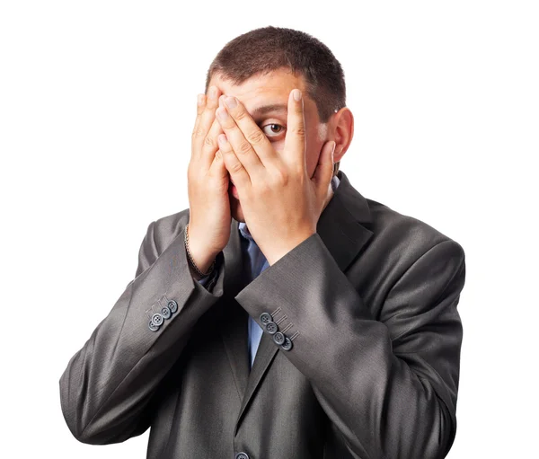Triste homem de negócios cobrindo rosto por mãos e olhando através de finge — Fotografia de Stock