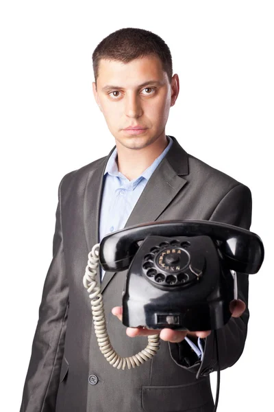 Młody biznesmen z retro telefon na białym tle na biały backgro — Zdjęcie stockowe