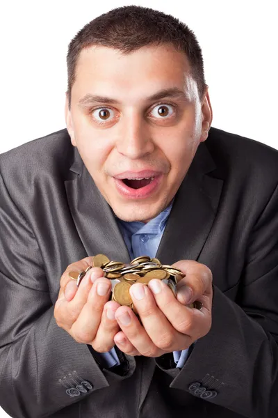 Emotional crazy young businessman with heap of coins isolated on — Stock Photo, Image
