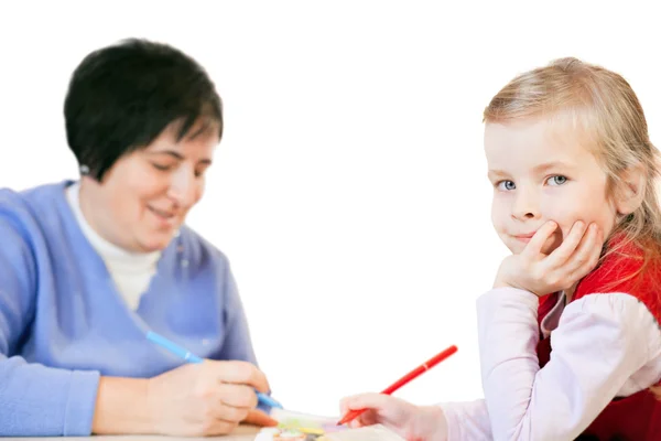 Smiling little girl and happy mature woman draws in an album, is — Stock Photo, Image