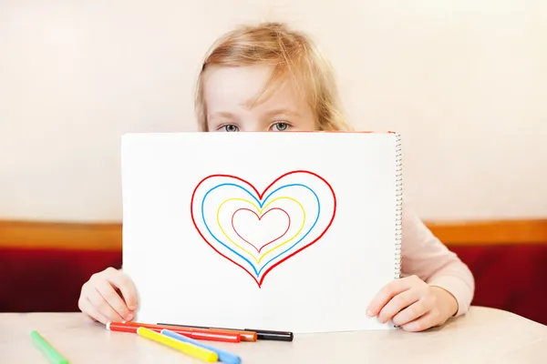 Little girl holding album with hearts. Valentine's Day — Stock Photo, Image