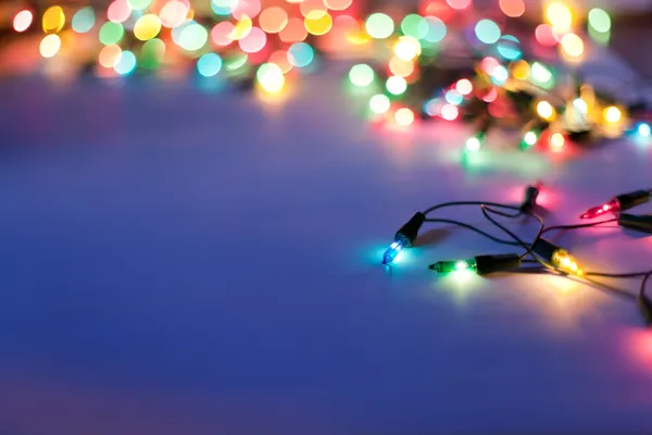 Christmas lights on dark blue background with copy space. Decora Stok Resim